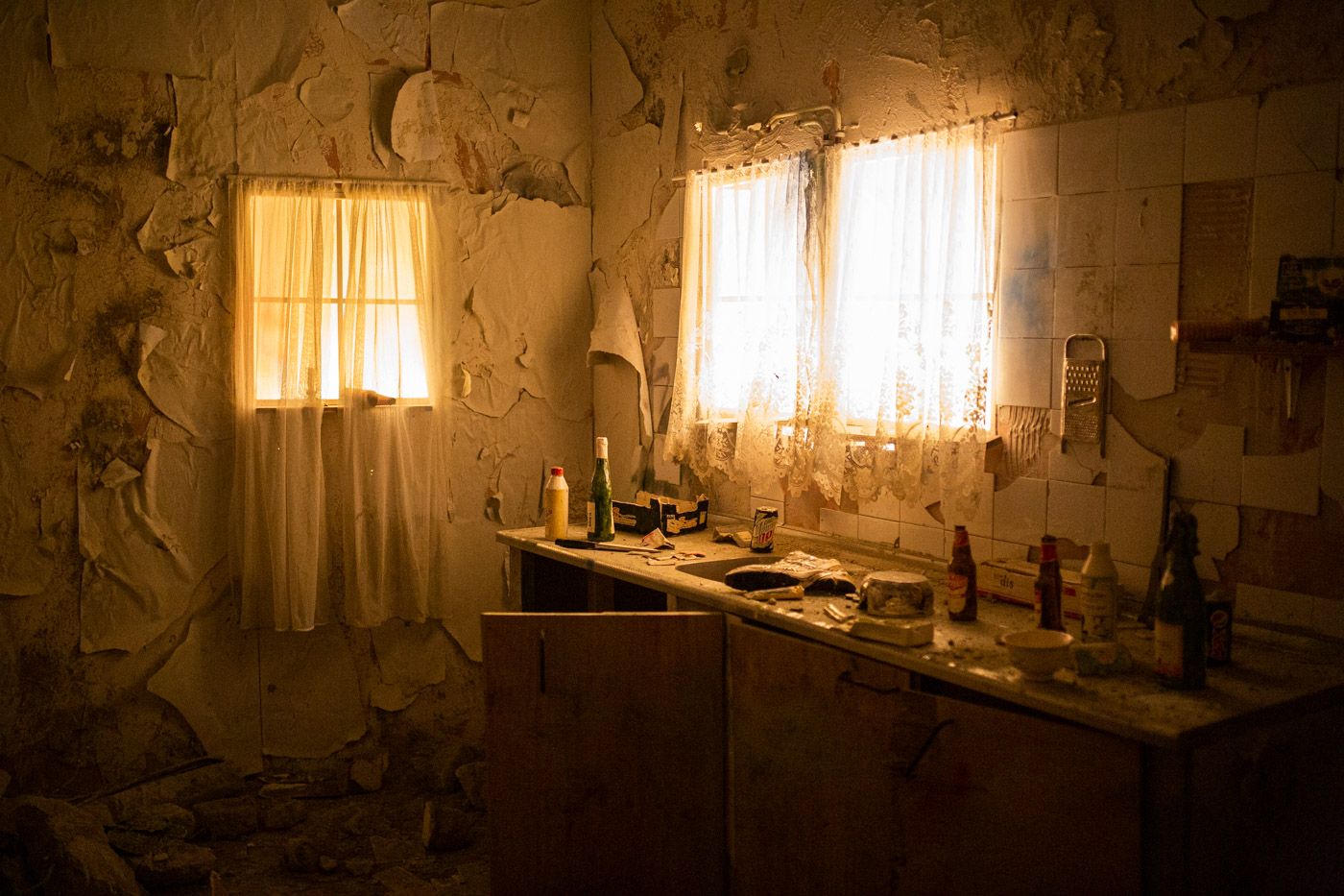 Eén van de kamers in het doolhof, wat een stoffige vernielde keuken is. Door de ramen van keuken komt er een schemerlicht binnen.
